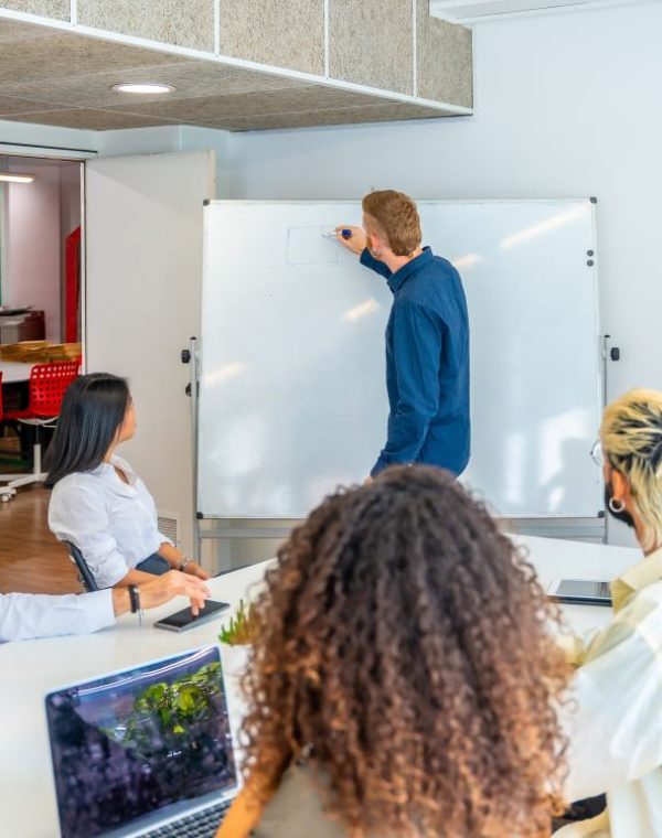 man-using-a-white-board-in-a-coworking-meeting